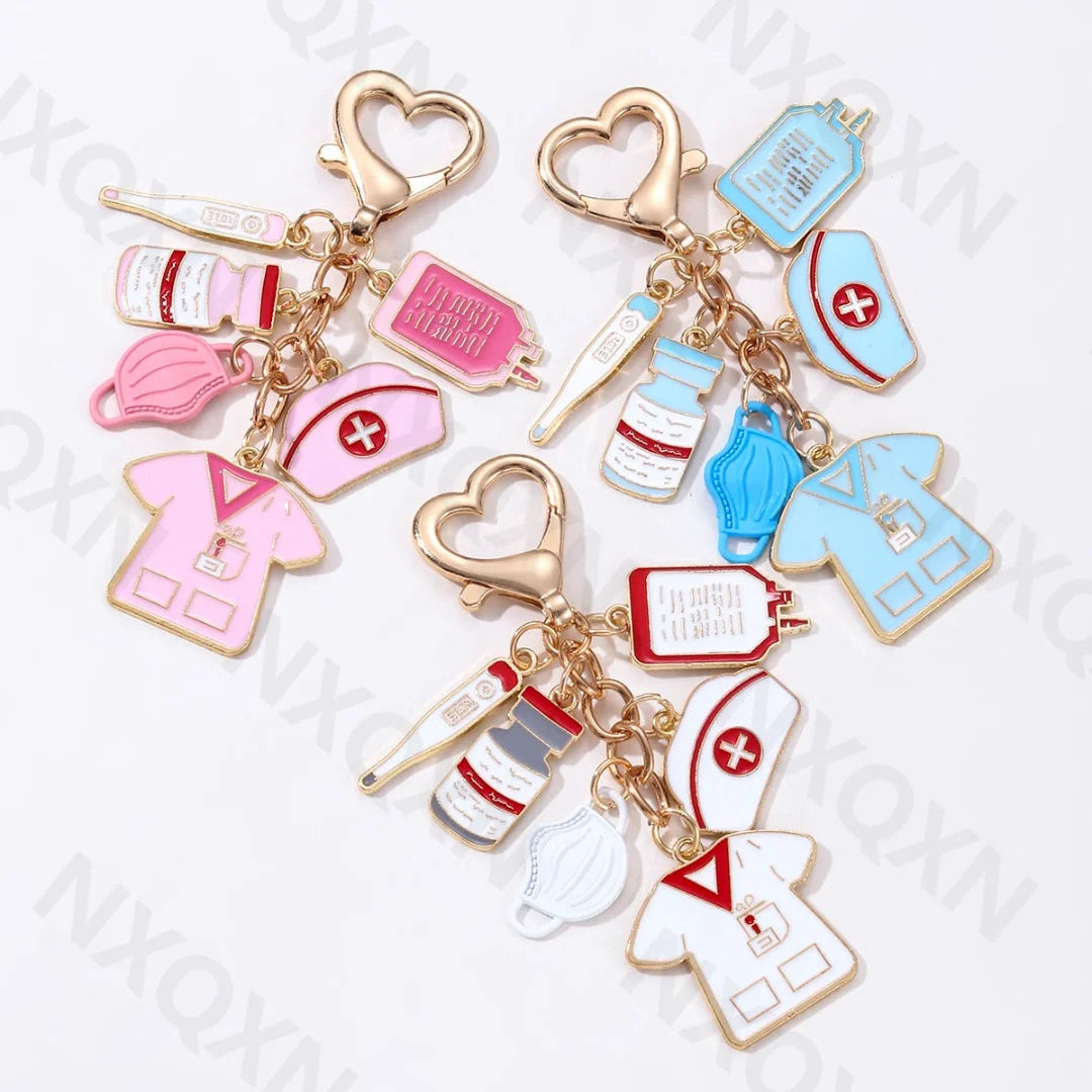 A set of cartoon infusion pump thermometer keychains in pink, blue, and white for medical professionals