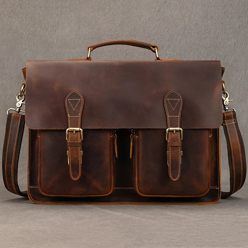 A brown vintage Crazy Horse leather briefcase with a top handle and two internal compartments.