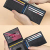 A black carbon fiber minimalist trifold wallet is shown being held open, displaying various credit cards and cash.