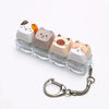 A set of acrylic cat keycaps used as a fidget toy with a silver metal lanyard.
