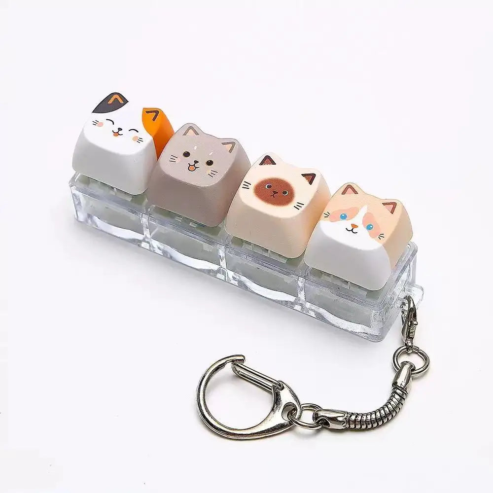 A set of acrylic cat keycaps used as a fidget toy with a silver metal lanyard.
