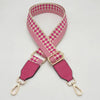 Pink and white checkered braided nylon bag strap with gold-toned metal hooks