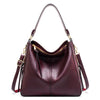 A deep burgundy vintage faux leather hobo shoulder bag with gold hardware.