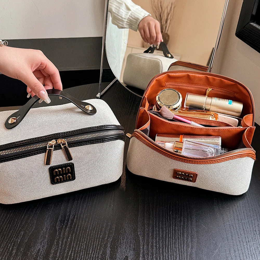 A brown leather toiletry bag is open, revealing various cosmetic and grooming products on a dark wooden surface.