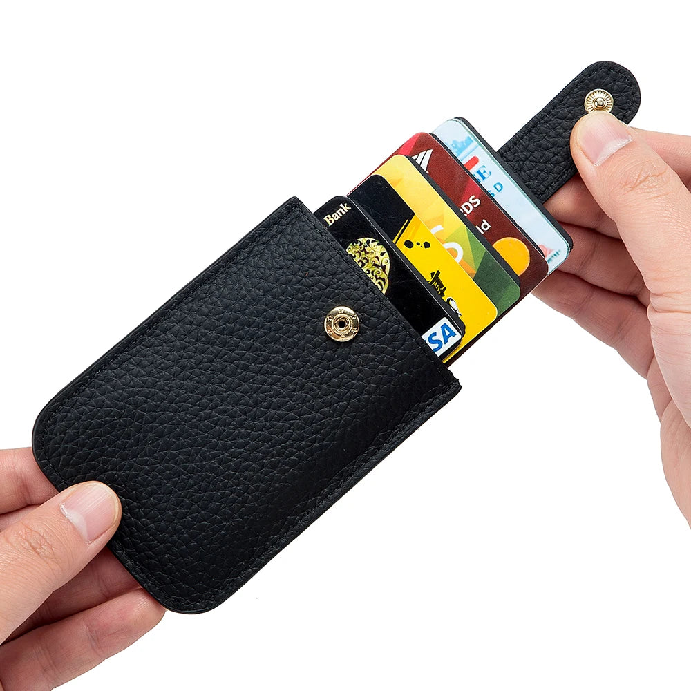 A black genuine leather slim card holder displaying various credit cards and IDs.