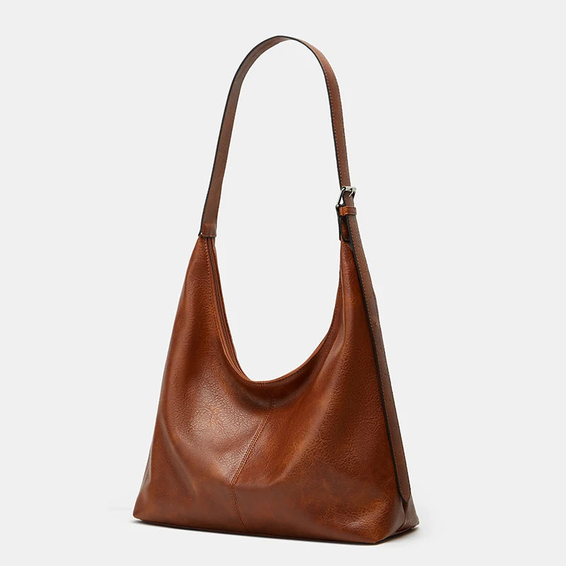 A brown soft PU leather retro tote bag with a long strap and zipper closure.