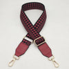 A braided nylon bag strap in black and maroon checkered pattern with gold metal hooks.