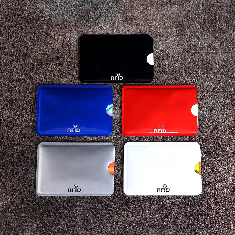Four RFID protection card sleeves in black, blue, red, and white are displayed on a dark surface.
