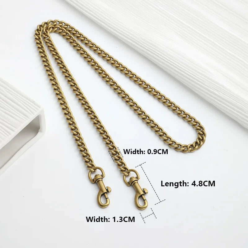 A gold-colored metal chain strap for bags, shown with dimensions of 0.9cm width and 4.8cm length.