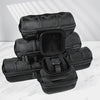 A stack of black premium leather watch organizer travel cases on a white marble surface.