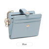 A light blue minimalist wallet with a flap closure and gold-toned hardware.