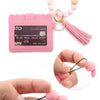 A pink silicone bead bracelet is shown next to a leather card holder and loose beads being held by a hand.