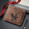 A brown embossed PU leather slim wallet with an eagle design is shown next to a red ribbon and a pen.