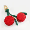Red cherry fruit shape coin purse keychain with gold hardware and green fabric strap