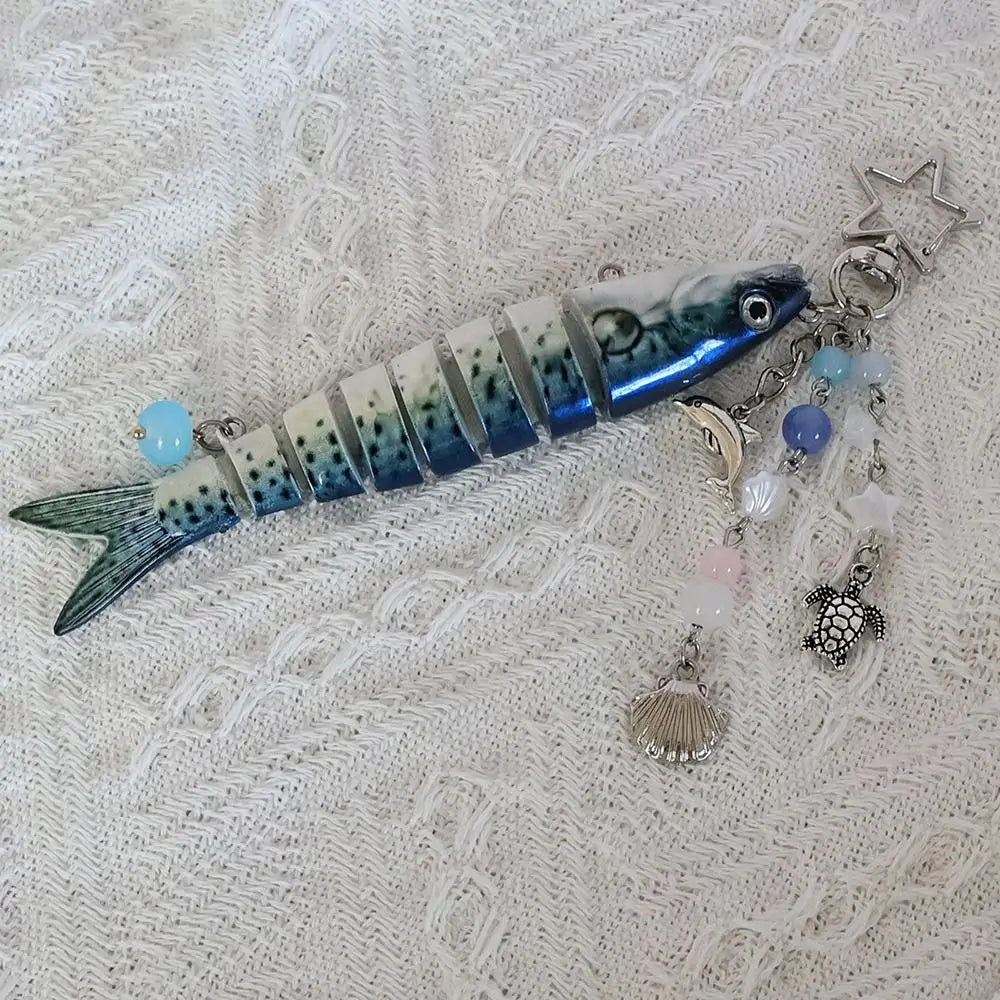 A realistic simulation fish keychain featuring blue and white stripes and various colored beads.