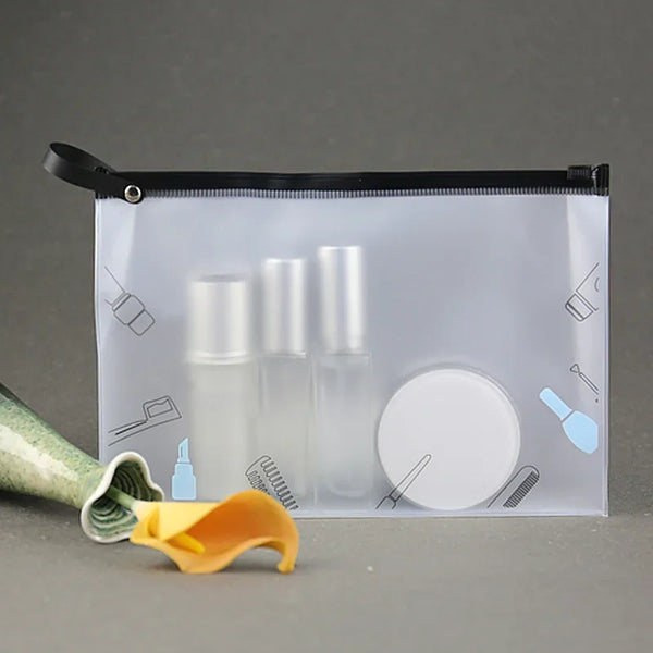 A clear plastic cosmetic storage bag with a black zipper holds several glass bottles and a yellow applicator tool.
