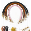 A rainbow of replaceable leather bag handles with metal buckles in various shades including black, brown, pink, and beige.