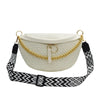A cream-colored woven pattern waist bag with gold chain straps and a black patterned strap.