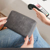 A hand holds a dark gray passport holder, protected by an RFID blocking device, emphasizing theft protection for travel docum