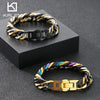 A chunky gold and black Cuban link bracelet worn on a dark surface.