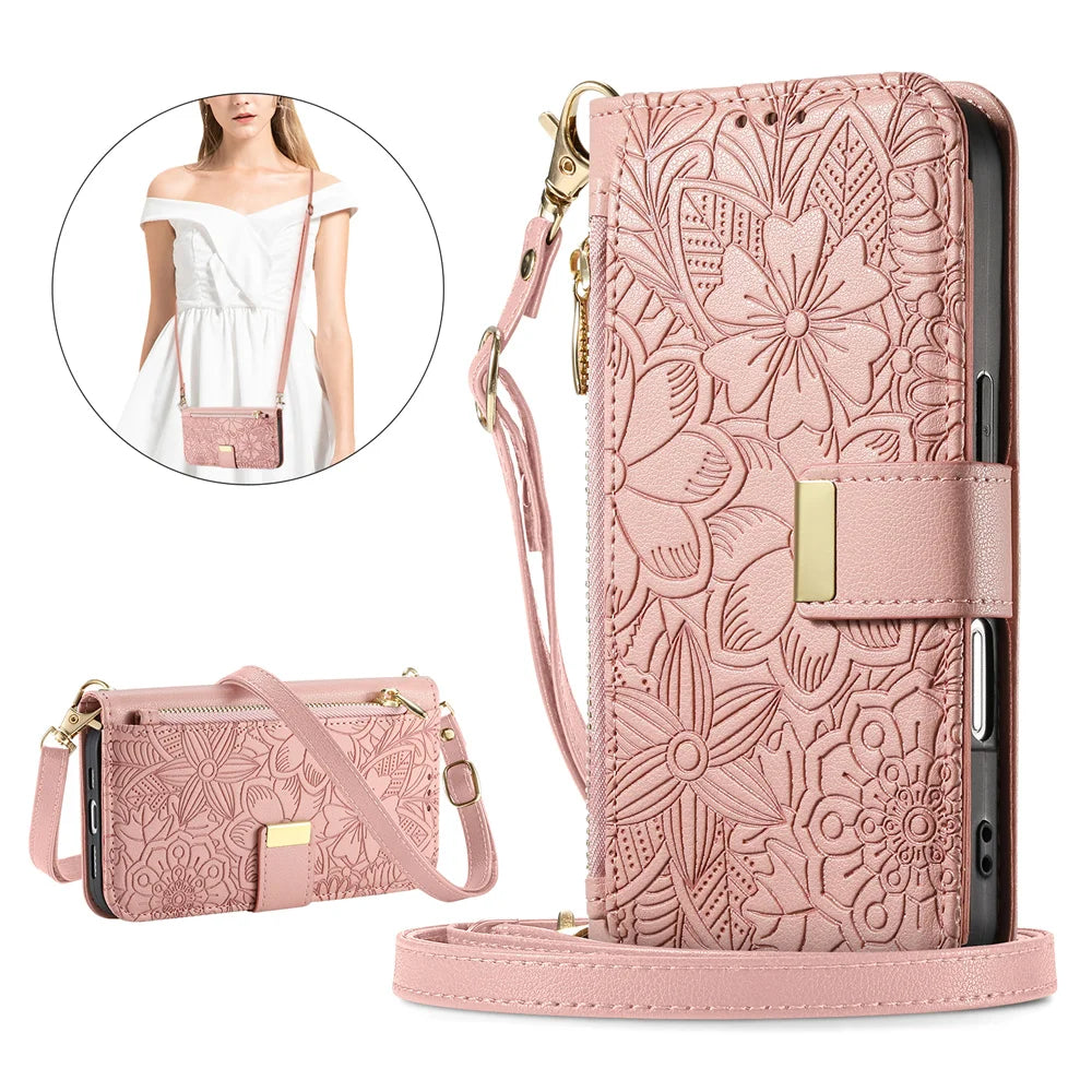 A pink zippered leather crossbody phone wallet case for an iPhone featuring a detailed floral pattern.