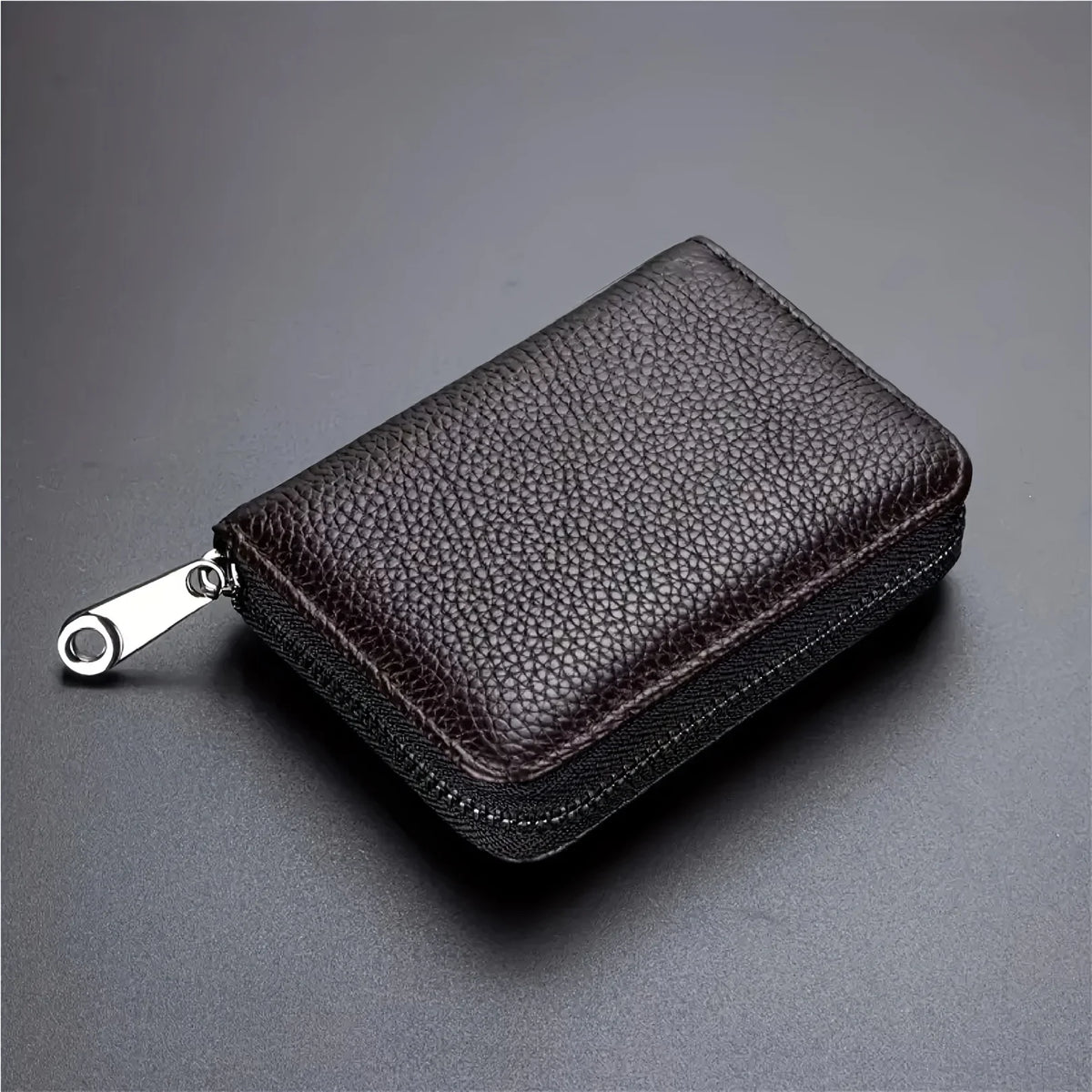 A dark brown leather minimalist RFID blocking card wallet with a zipper pouch shown from above.