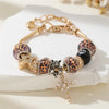 Gold beaded bracelet featuring leopard print beads, a star charm, and a black bead with a cross pendant.