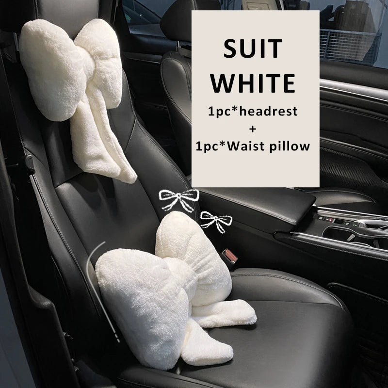 White car seat accessories including a headrest pillow and a waist pillow shown in a car interior.