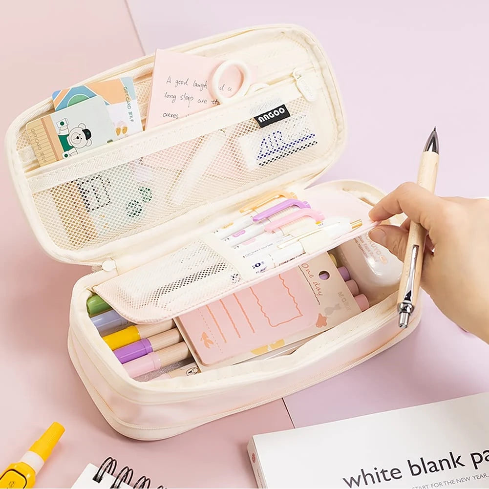 A light pink pencil case is open, showing various colored pencils and stationery inside.