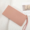 A pale pink elegant PU leather coin purse and card holder resting on a white textured fabric.