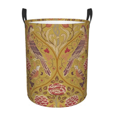 A vintage floral laundry hamper with a yellow background featuring pink and green birds and leaves.
