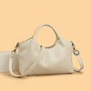 A beige leather women's casual crossbody shoulder bag with a zip closure displayed on a light background.