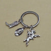 Silver keychain set featuring a cowboy boot, hat, and horse silhouette charms.