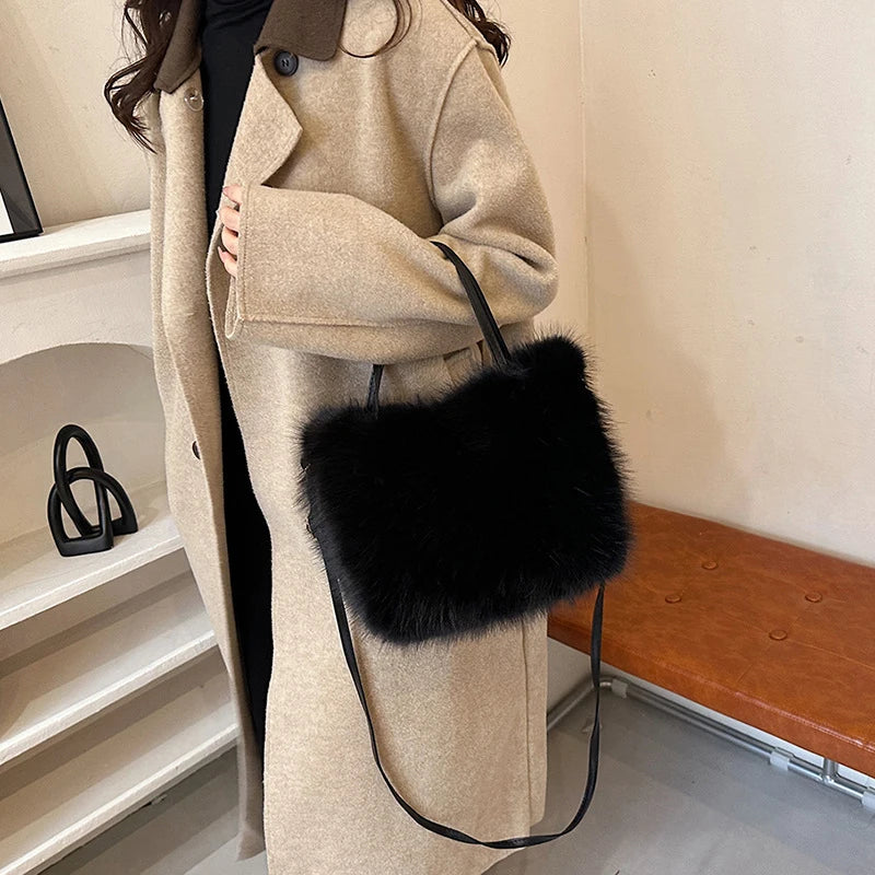 A beige trench coat featuring a black faux fur tote bag with a thin strap.