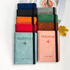 A stack of vintage PU leather passport wallets in various colors, including blue, black, orange, red, and pink.