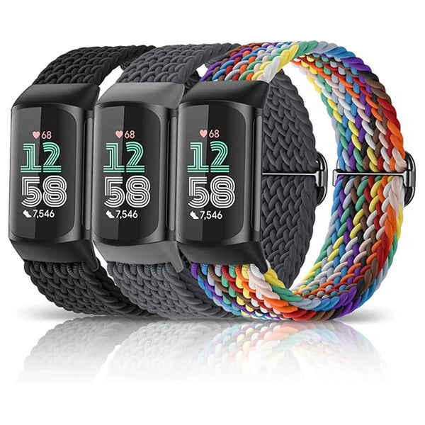 A black nylon watch band with three digital displays is shown coiled on a reflective surface.