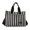 Sac bandoulière en toile à rayures noires et blanches avec poignées noires.