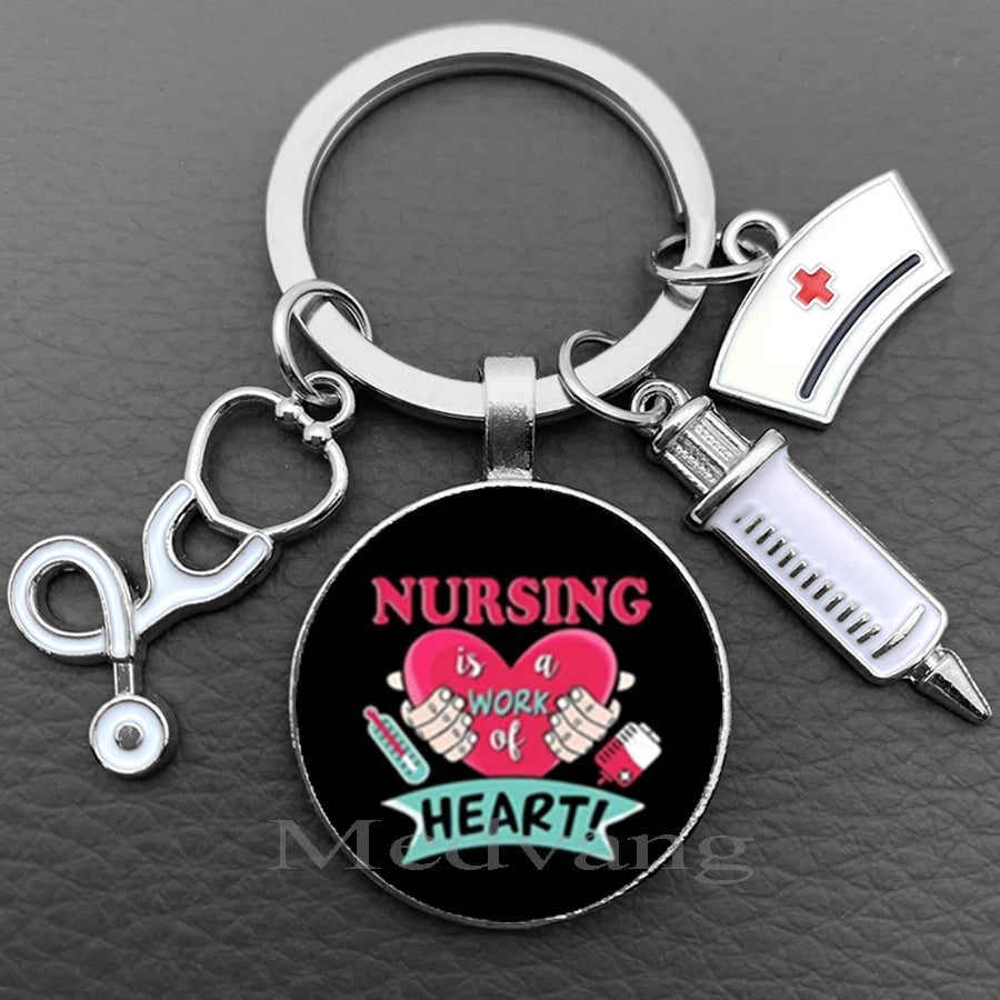 Silver keychain featuring a stethoscope charm and a circular pendant with the text Nursing is a work of heart