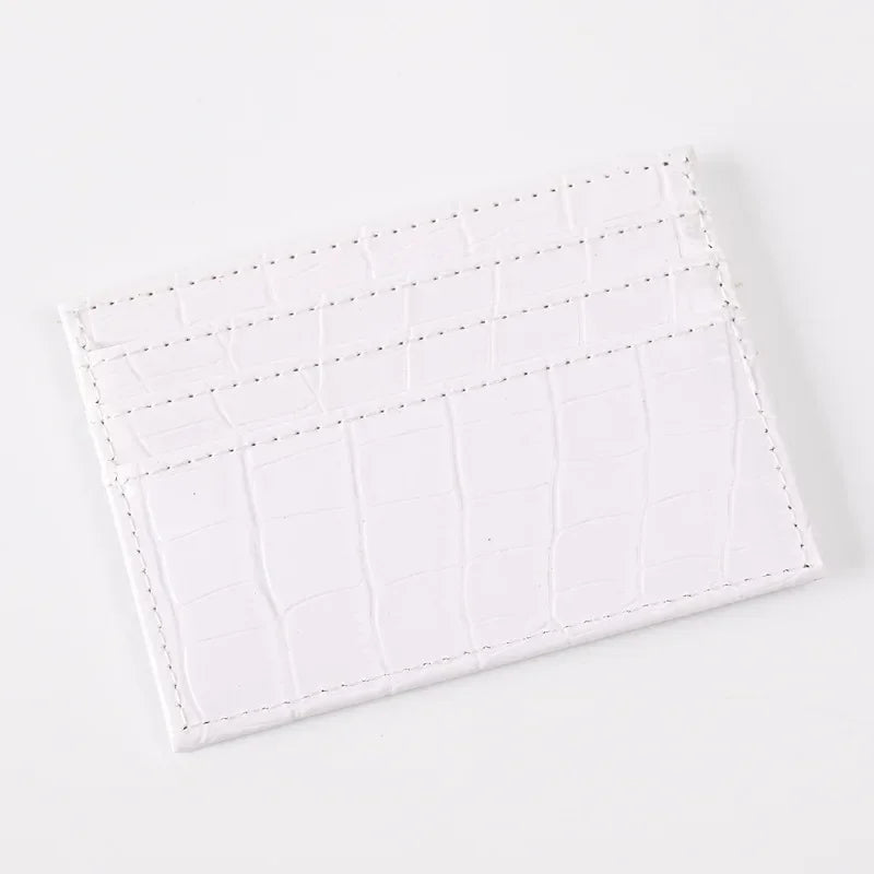 A white slim PU leather card holder wallet with a textured crocodile pattern.