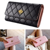 A black quilted long wallet with a gold crown buckle shown in various angles.