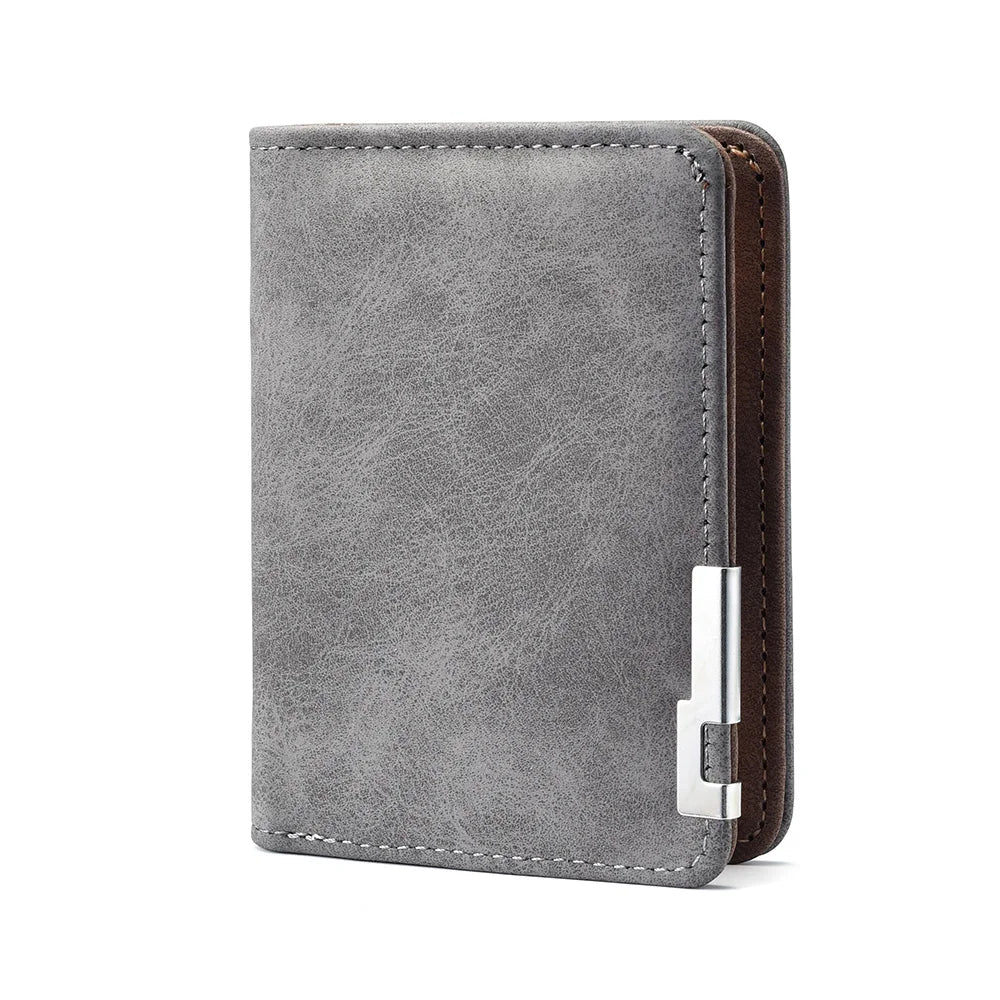 A grey leather wallet with a brown stitched edge and a silver card slot.