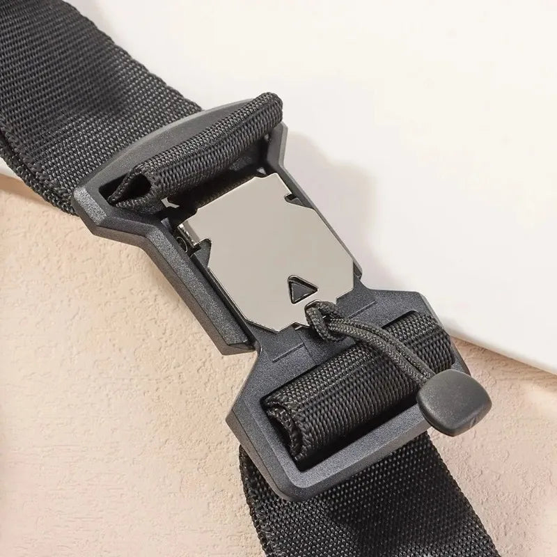 A close-up of a black magnetic quick release buckle attached to a nylon strap.