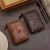 A brown leather slim wallet and a black pen are displayed on a gray surface.