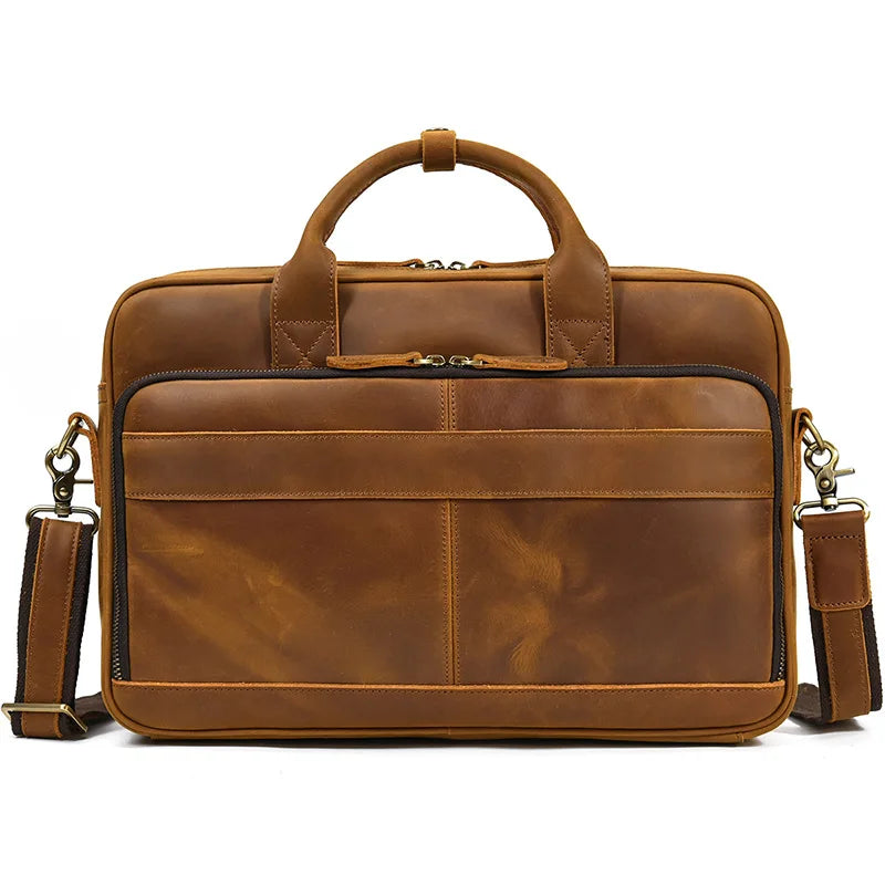 A brown vintage genuine leather briefcase with a leather handle and shoulder strap.