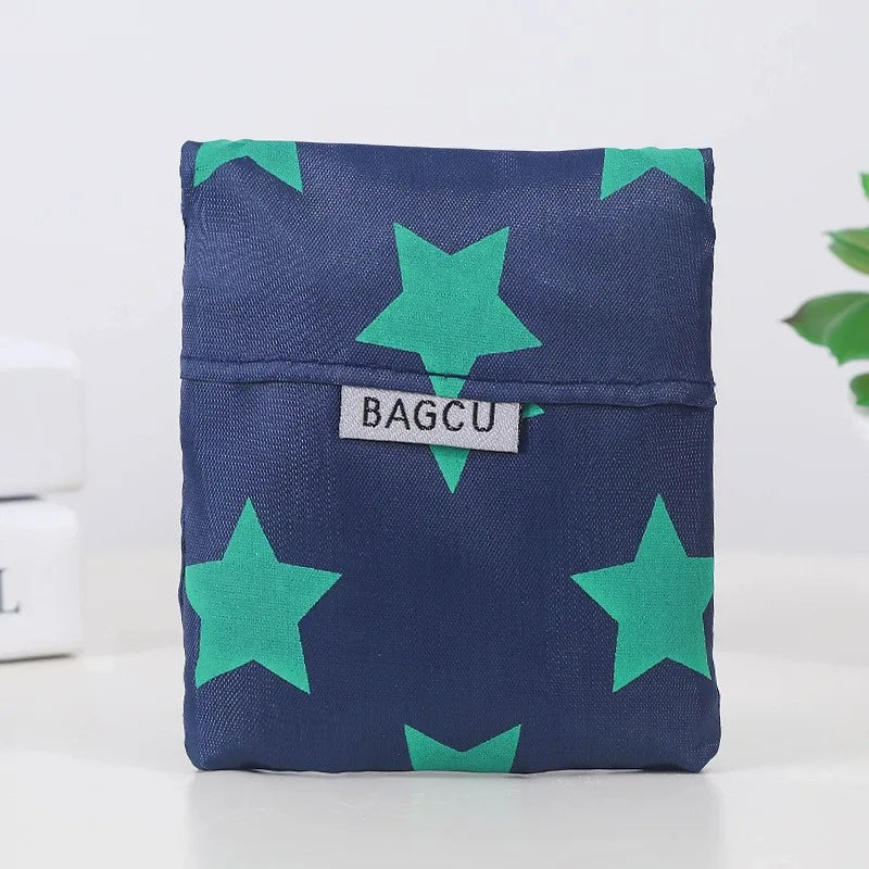 A dark blue fabric pouch with a repeating pattern of bright green stars.