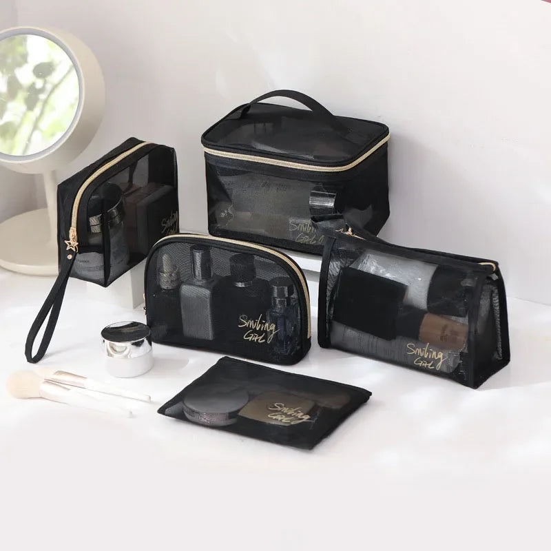 A collection of black mesh cosmetic storage pouches and a mirror on a white surface.