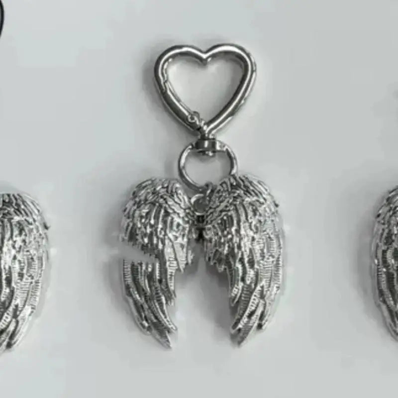 Silver metal angel wing keychain charm with a heart loop.