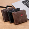 A brown leather bifold wallet with a black sleeve is shown next to a silver pen on a wooden surface.