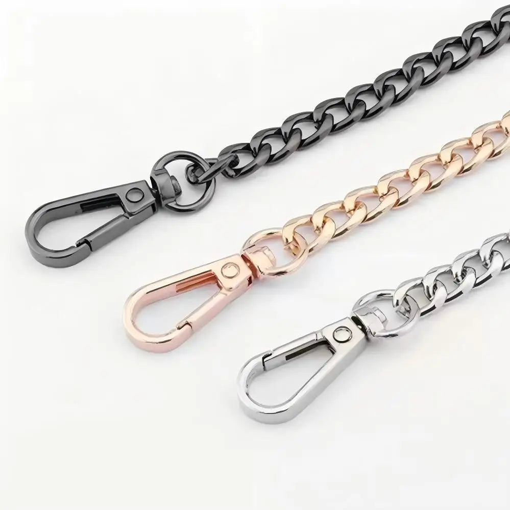 Three metal chains in black, gold, and silver with lobster clasps displayed against a white background.