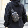 A black hooded jacket is shown with a brown leather sling bag attached to the back.